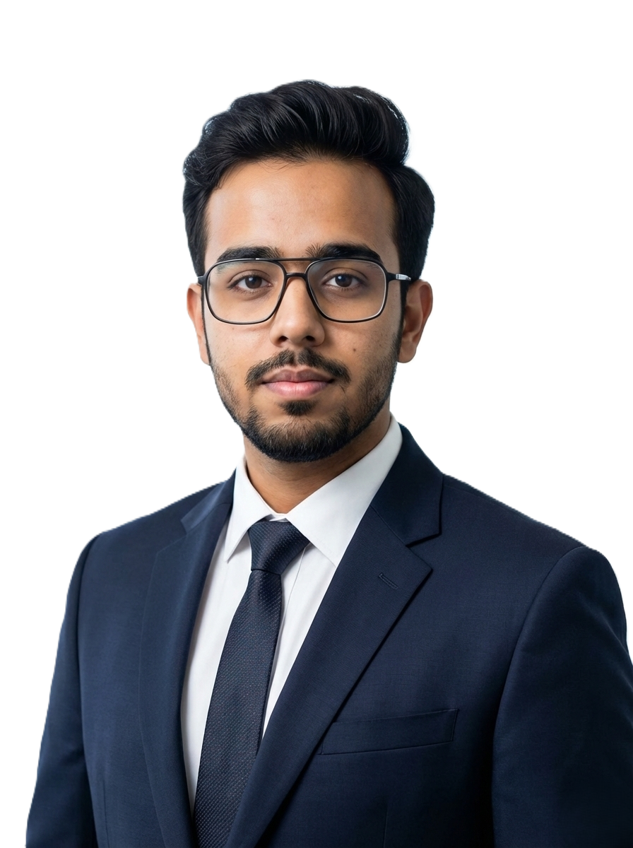 Portrait of a man in a navy suit and glasses, standing in a bright office with a city skyline in the background.